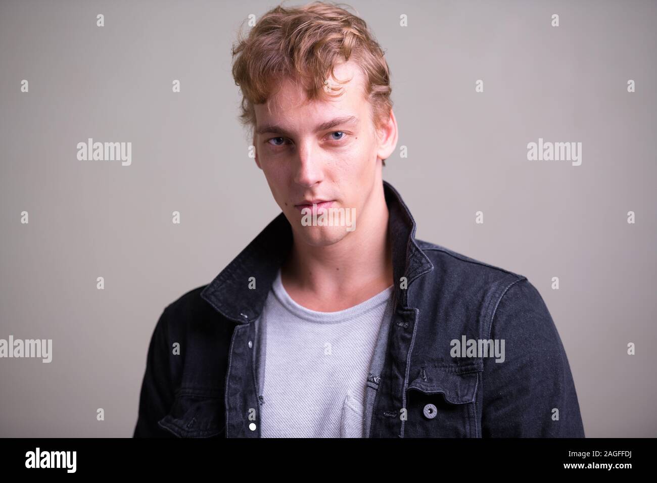 Face of young handsome man with curly hair Stock Photo - Alamy