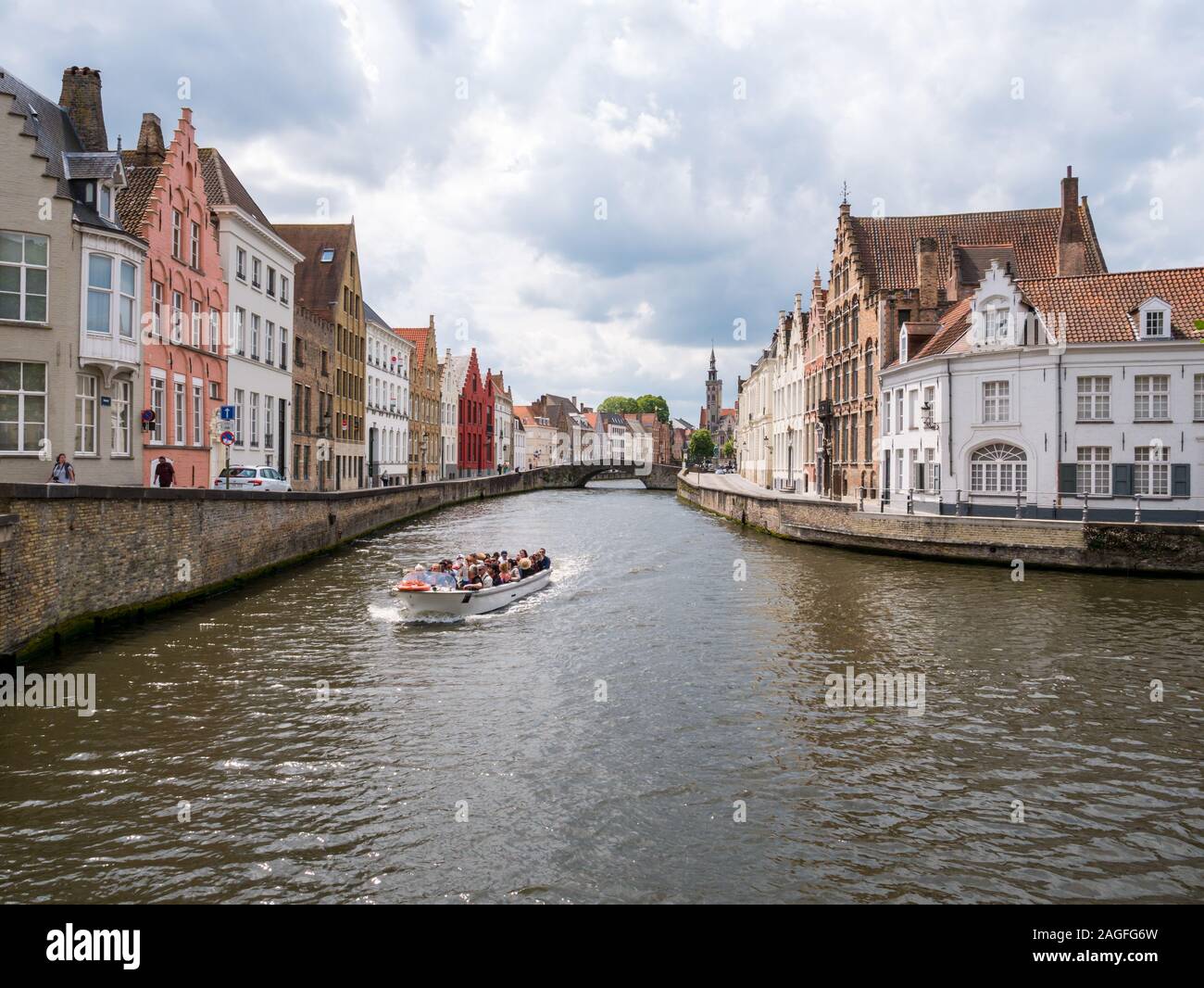 Boat tour on historic Spiegelrei canal in old town of Bruges, Belgium Stock Photo