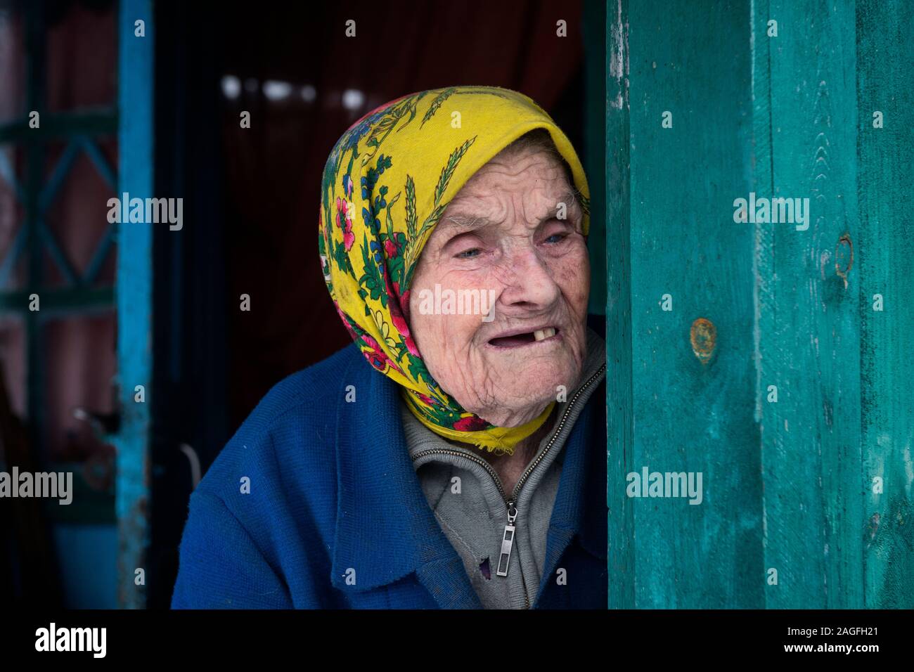 Maria Shovkuia, 98 years old. She is one of the babushkas who refused to leave her home inside the Chernobyl Exclusion Zone. Some months after the evacuation (following the Chernobyl disaster 1986) she and her husband turned back to their farm. After his death she is living as the last self settler alone and isolated in her village. Maria lived through Stalin's Holodomor – the genocide-by-famine of the 1930s that wiped out millions of Ukrainians – and then the Nazis in the 1940s.After the Chernobyl accident many were simply unwilling to flee an enemy that was invisible.Chernobyl Exclusion Zone Stock Photo