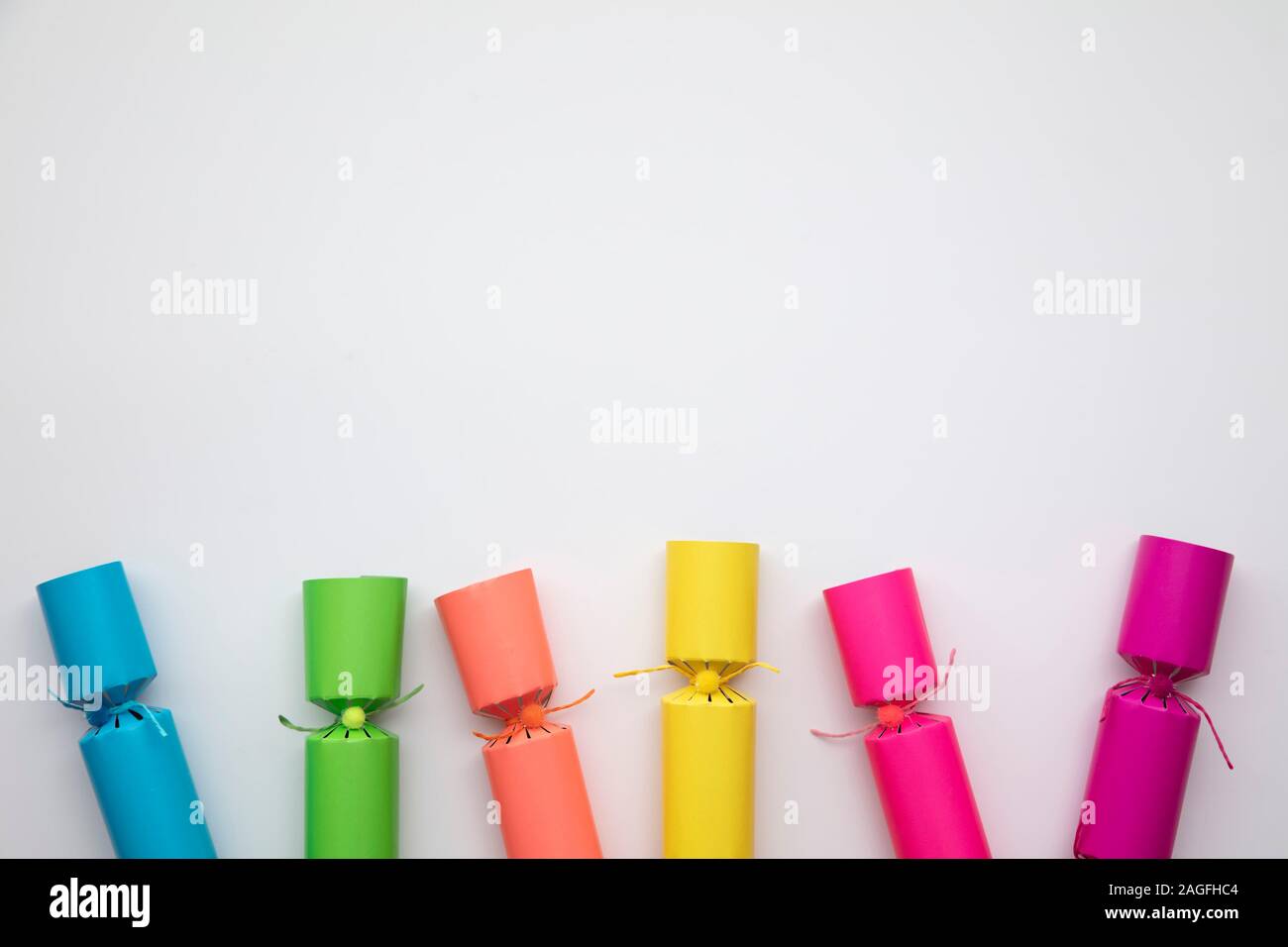 Bright colourful hristmas crackers on a plain background. festive layflat  Stock Photo - Alamy