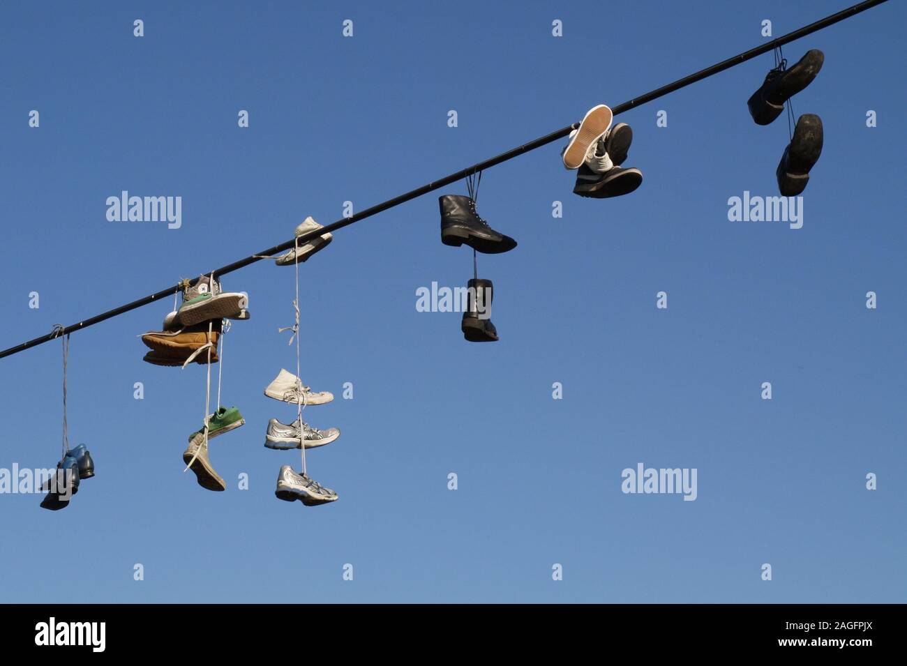 Shoes hanging on a cable Stock Photo Alamy