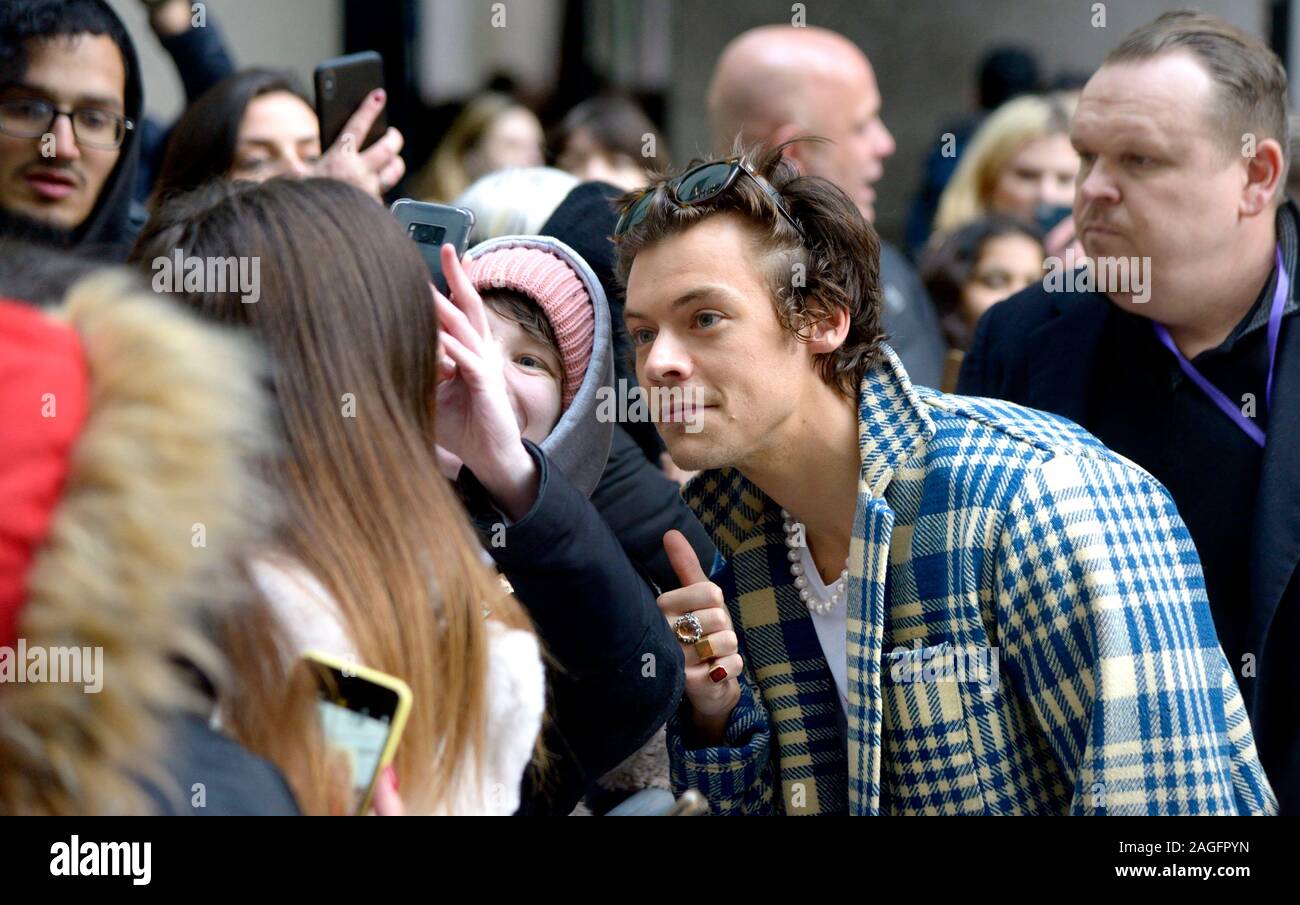 Harry Styles - One Direction Ssinger - meeting a large crowd of fans  outside BBC Broadcasting House after doing an interview for Radio 1 to  promote hi Stock Photo - Alamy