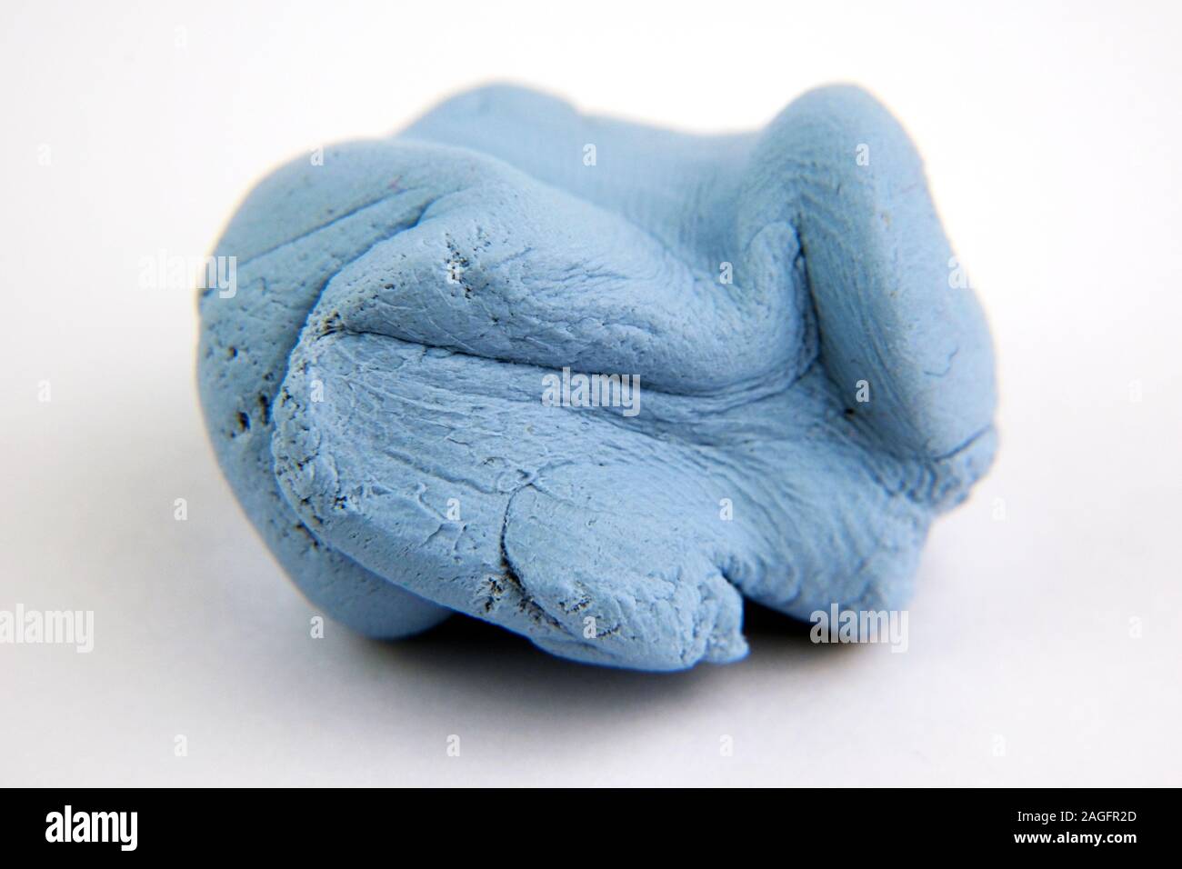 Macro photo of Blu Tack with visible grainy texture. Photo with selective focus. Stock Photo