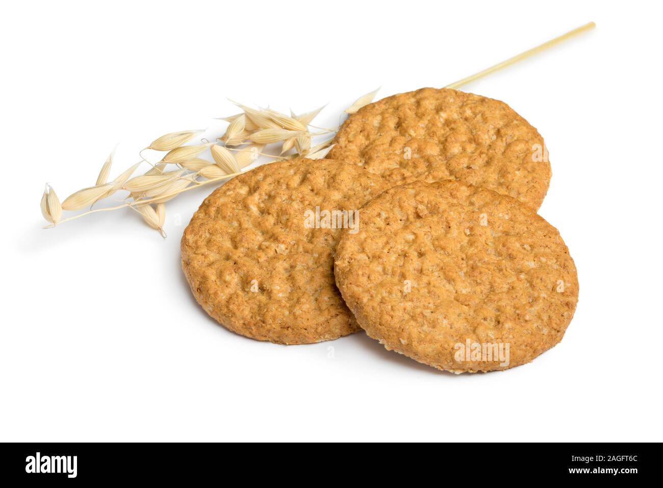 Crunchy healthy oat cookies and an ear of dried oat isolated on white background Stock Photo
