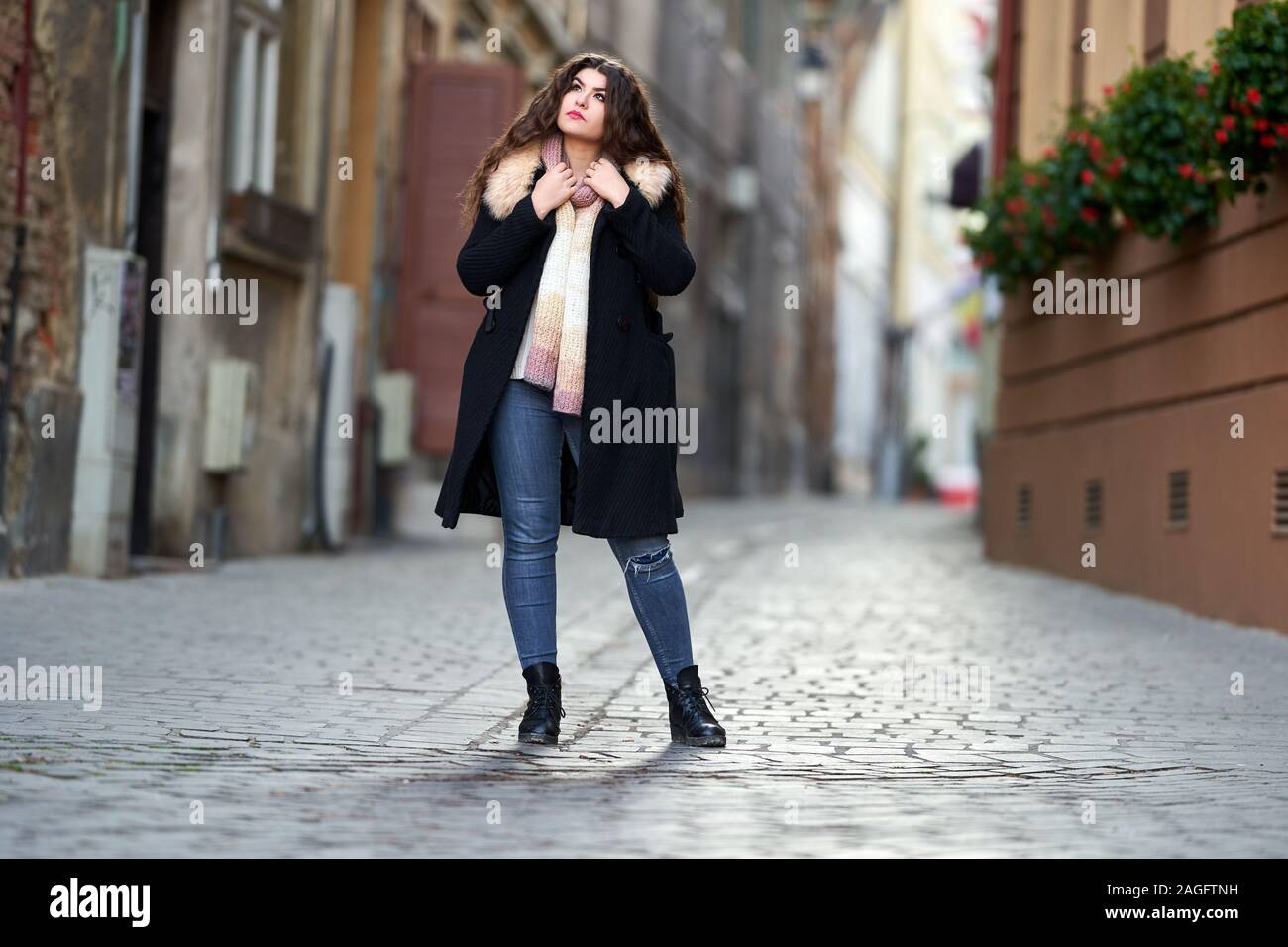 black coat and blue jeans