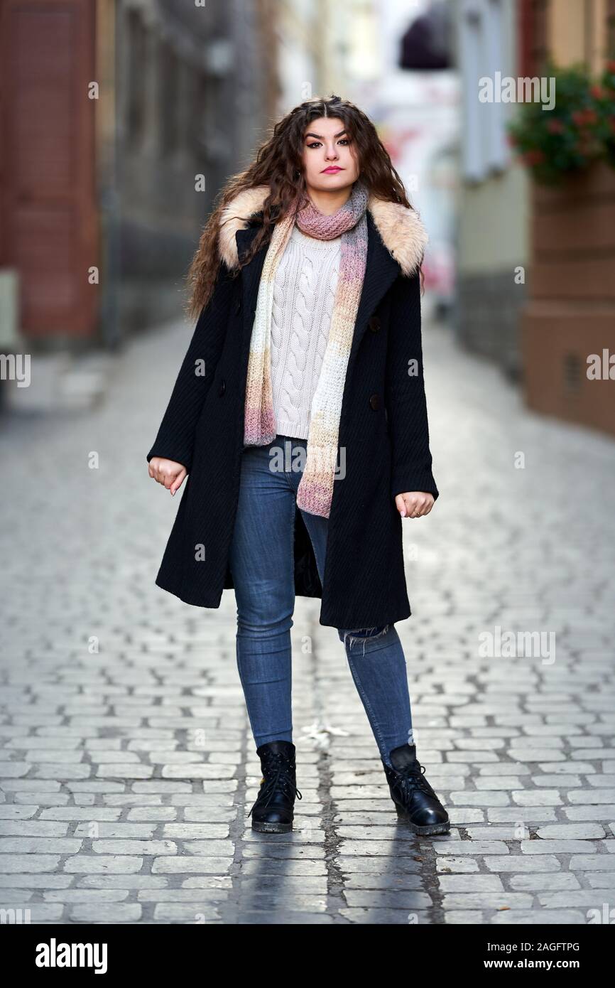 black coat and blue jeans