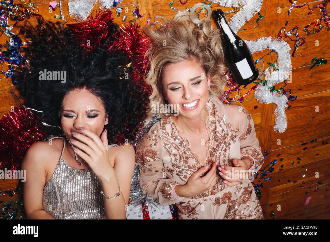 Two young women having a crazy birthday party in the night Stock Photo