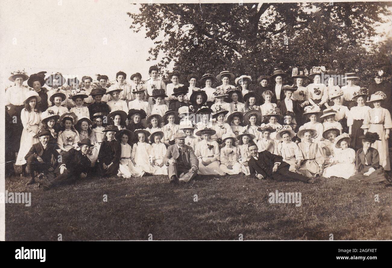 Vintage black and white postcard photo of a big group of Edwardian women. Stock Photo