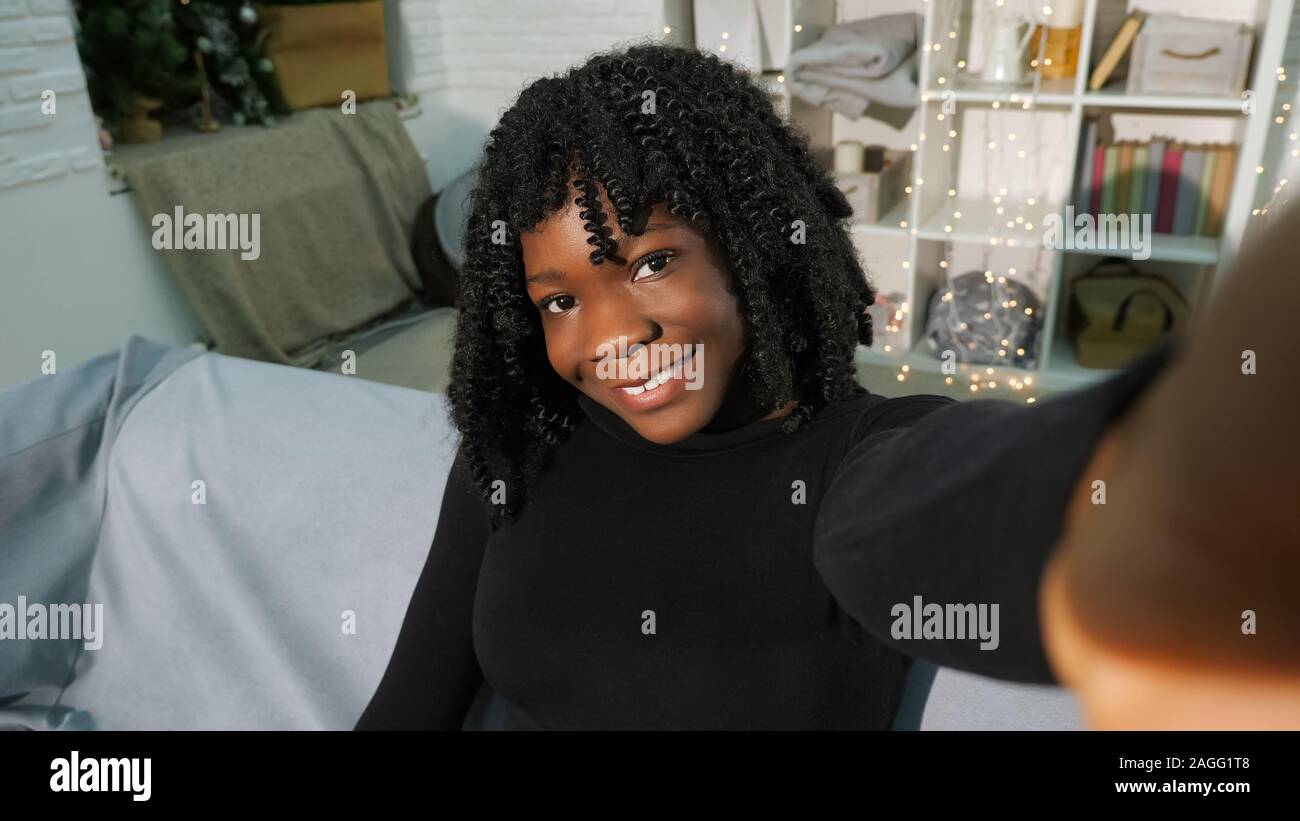 Attractive Young Black Woman With Curly Hair Looks Smiling