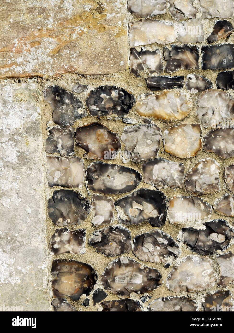 Detail of knapped flint wall with stone quoins, part of the porch wall