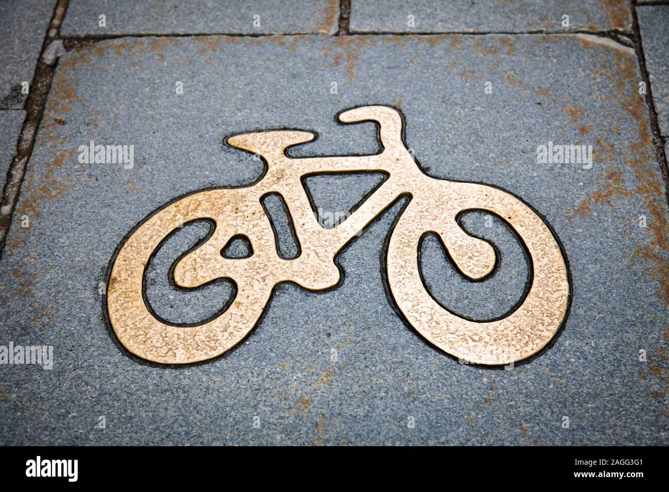 Bike lane sign made of brass or bronze in granite tile on a cycle track in Stockholm, Sweden, Scandinavia Stock Photo