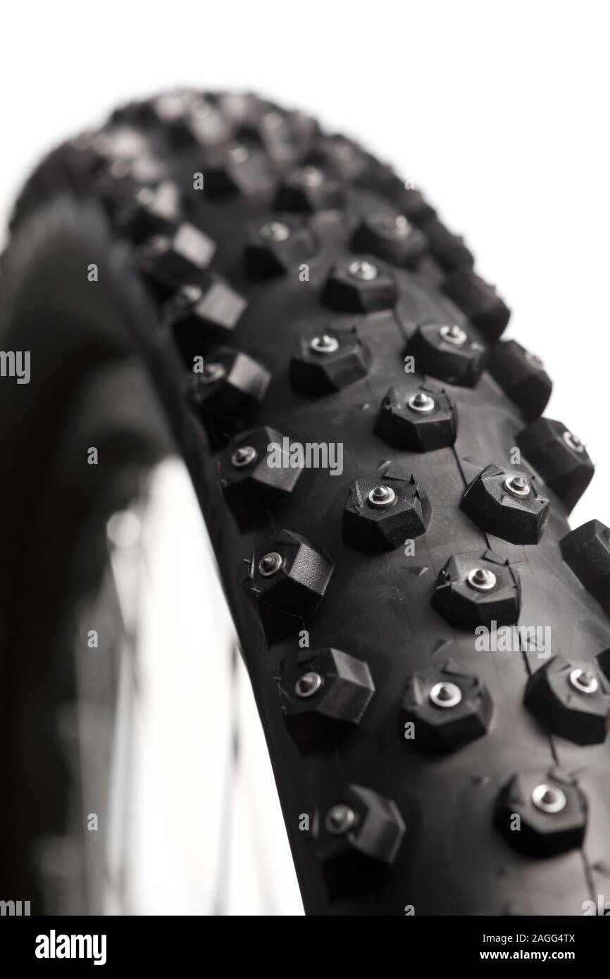 Knobby mountain bike winter tire with spikes close-up Stock Photo - Alamy
