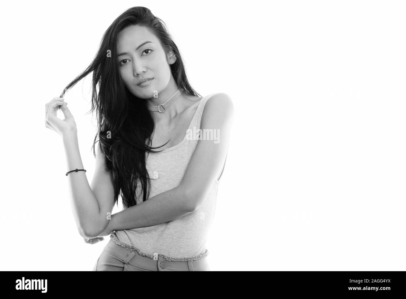 Studio shot of young beautiful Asian woman touching her hair Stock ...