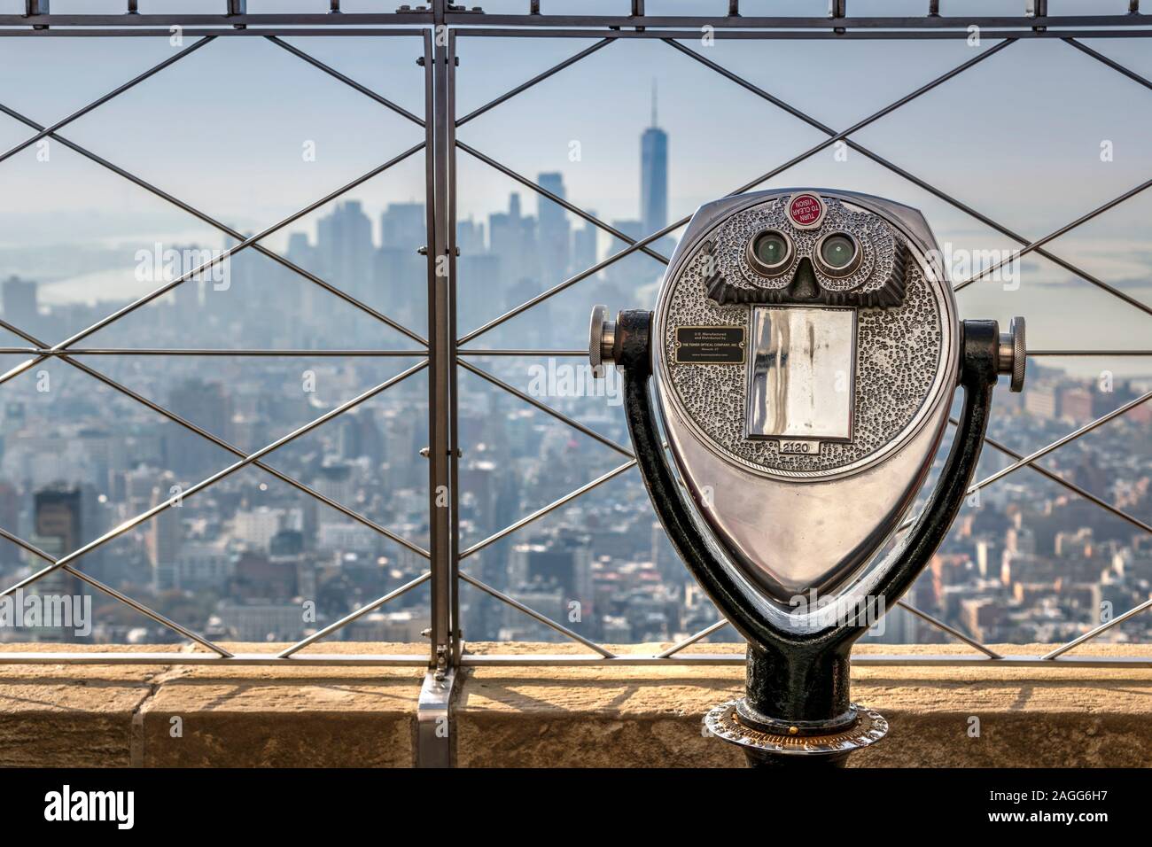 Telescope with blurred Lower Manhattan skyline in the background, Empire State Building's observation deck, Manhattan, New York, USA Stock Photo