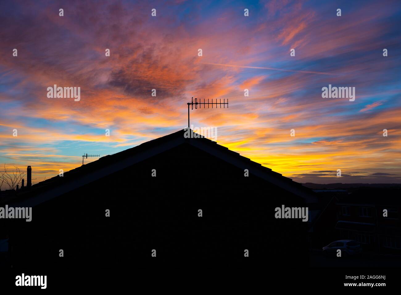 A beautiful Sunrise, sunset over a house in Longton, Fenton, Stoke on Trent in Staffordshire, TV aerial in silhouette Stock Photo