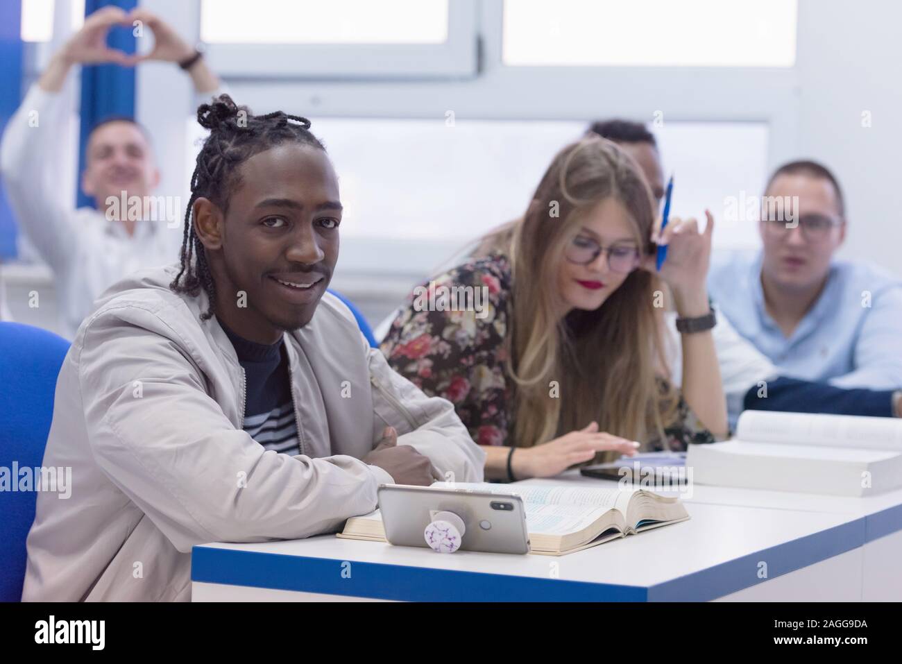 Smiling African American University Male Student In Classroom Sits