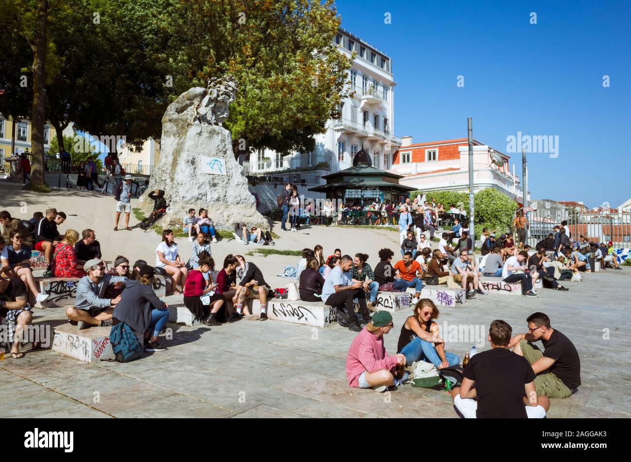 Lisbon, Portugal : Young people gather around the Adamastaor statue at the Miradouro de Santa Catarina viewpoint. Stock Photo