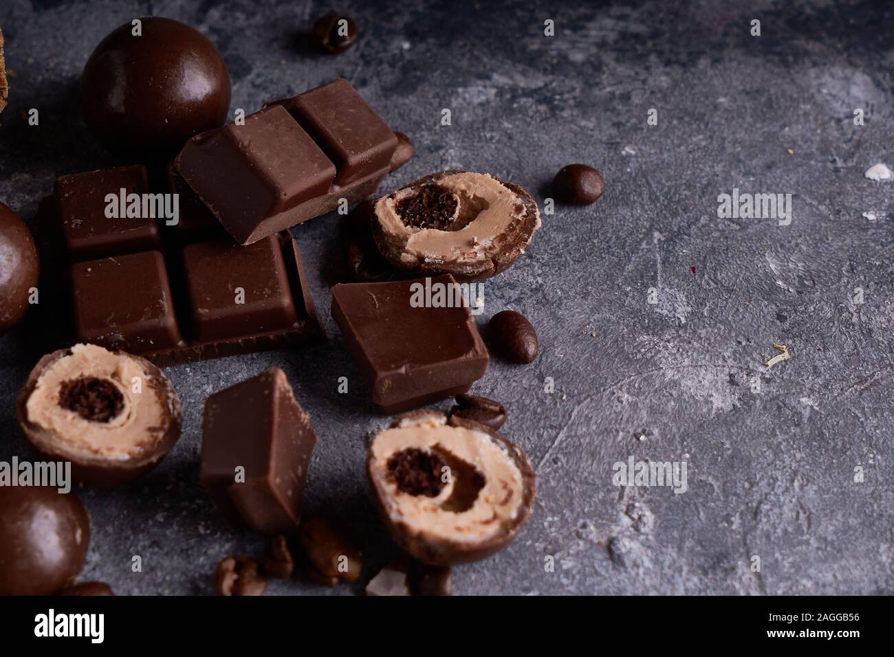 pieces of black and white chocolate, chocolates on a gray stone background  Copy space Top view Stock Photo - Alamy