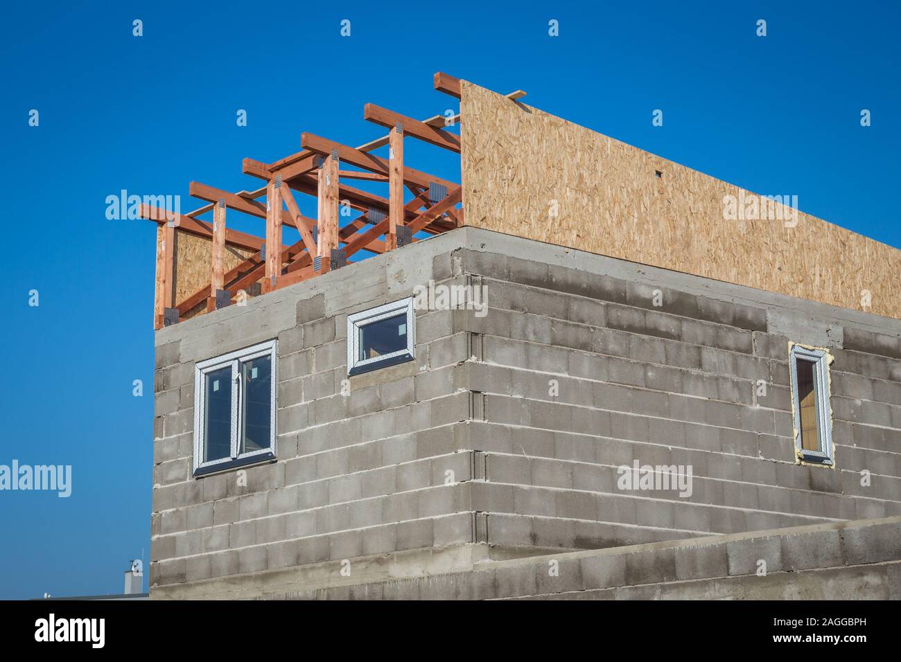 Roof construction installation of wooden beams at house construction