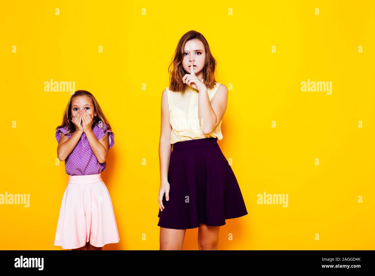 two beautiful girls close mouth silence and mystery Stock Photo