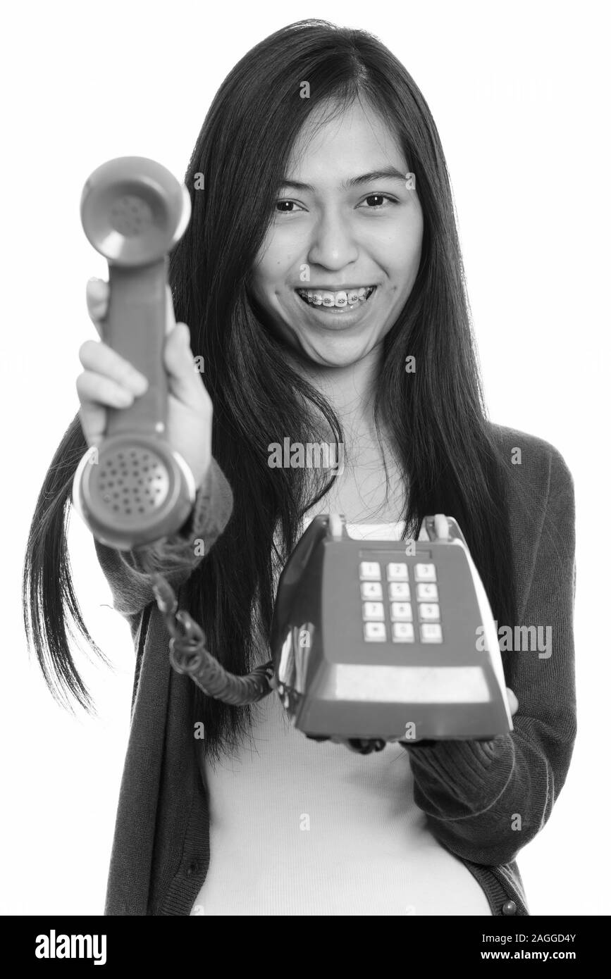 Close up of young happy Asian teenage girl smiling while giving old