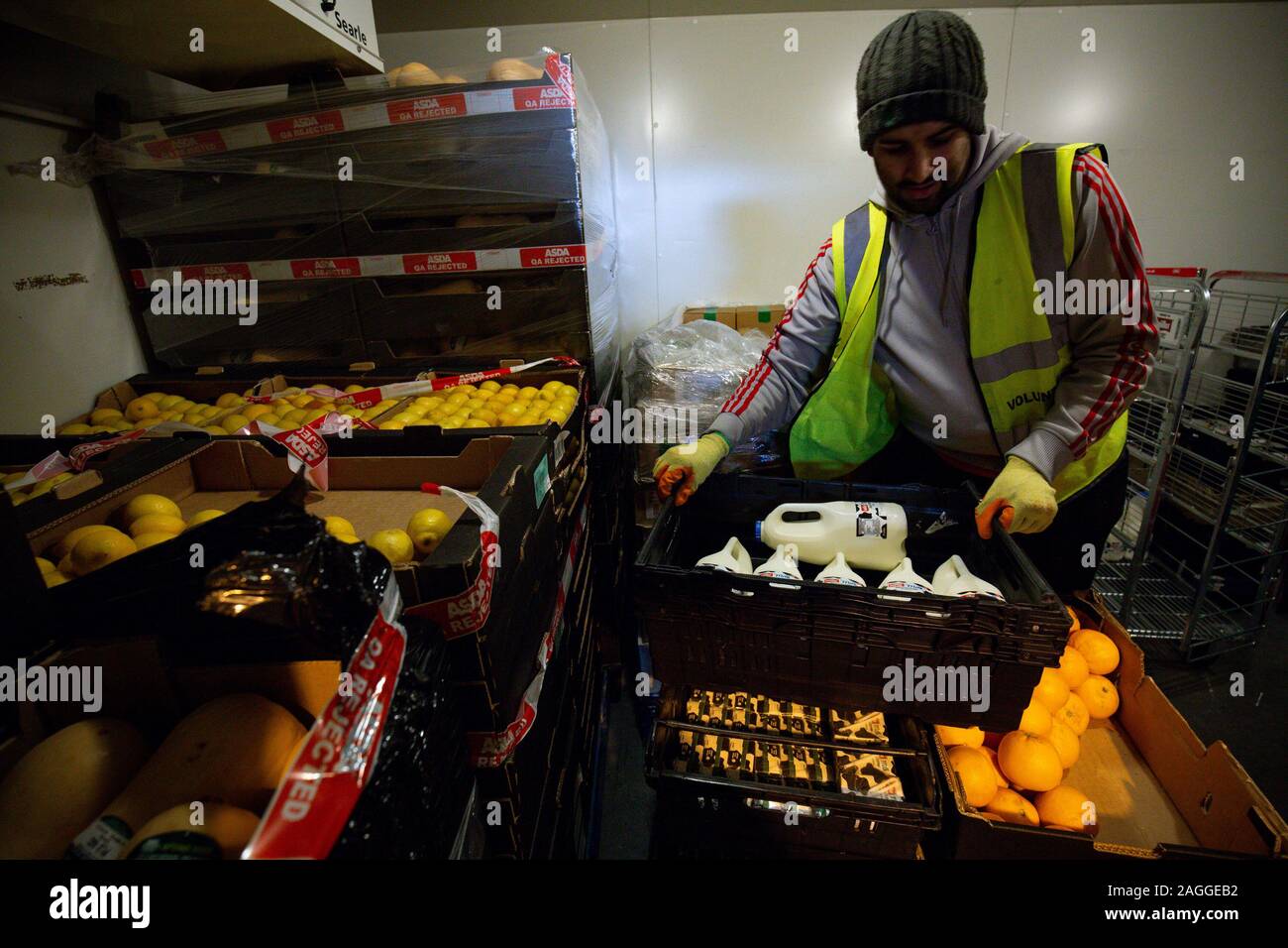 A volunteer in the FareShare warehouse in Birmingham. Britain's biggest food redistribution charity are experiencing their busiest period this Christmas with 25 warehouses serving 11,000 charities and community groups across the country. Stock Photo