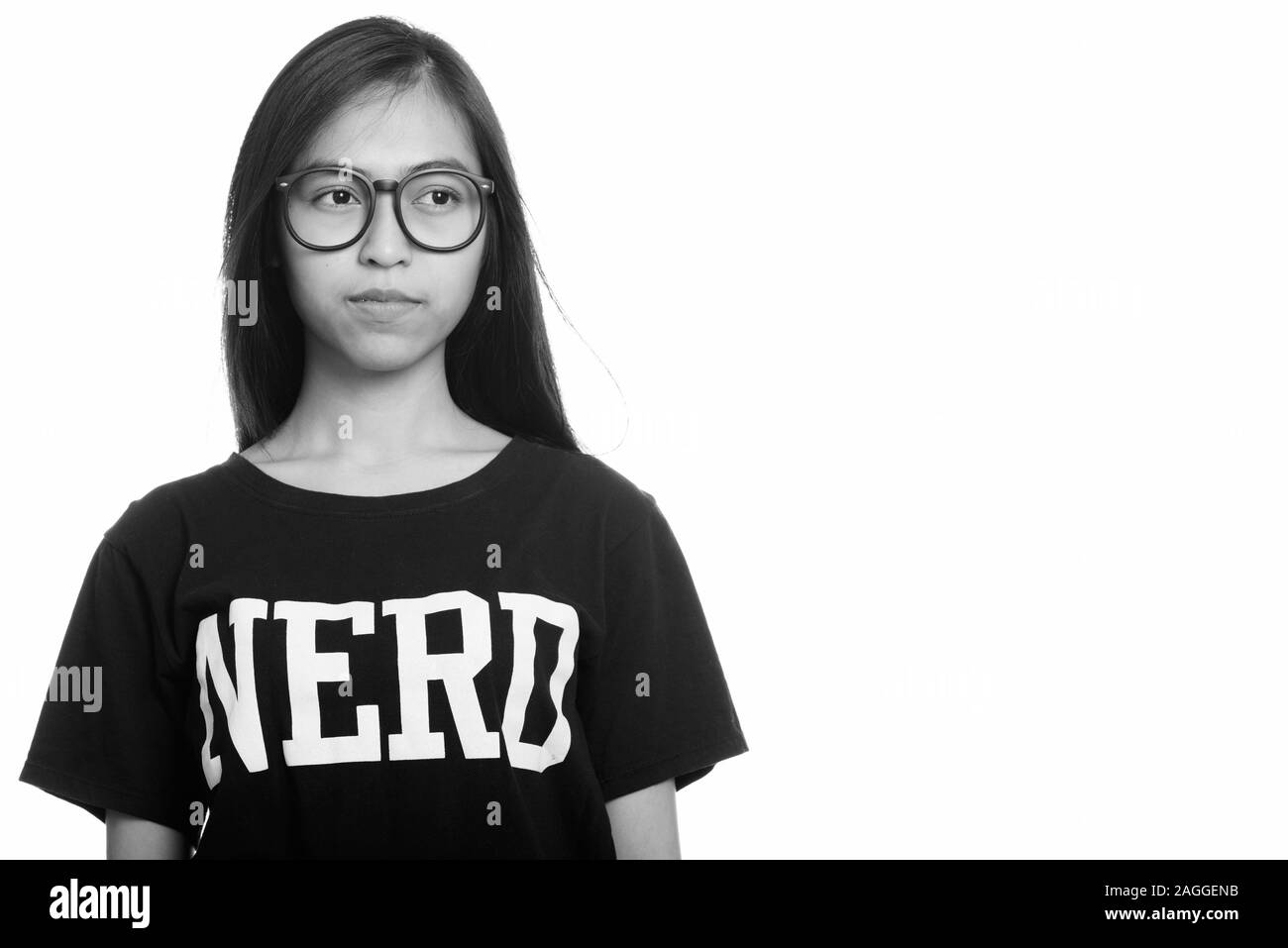 Studio shot of young Asian teenage nerd girl thinking Stock Photo Alamy