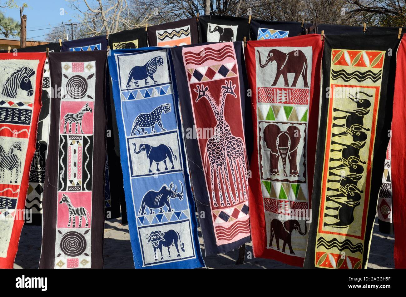 Traditional colourful Batik clothes for sale street market Chobe national park Botswana Africa Stock Photo