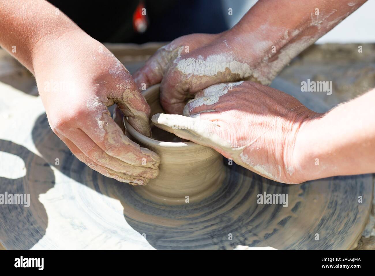Teaching in masterful studio of ceramics works with clay on a potter's wheel Stock Photo