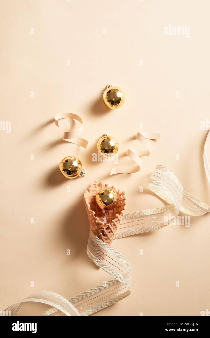 Ice cream waffle cone with ribbon and balls ornament topping. Skin