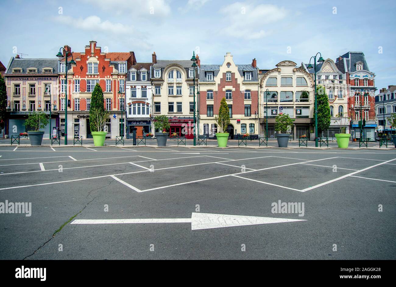 Lens (northern France): traditional art Deco building facades in place Jean Jaures' square, in the city centre. Empty parking spaces and arrow on the Stock Photo