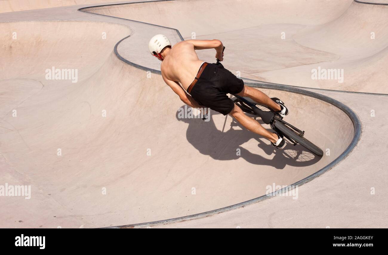 BMX rider boy in a skate-park riding bike Stock Photo