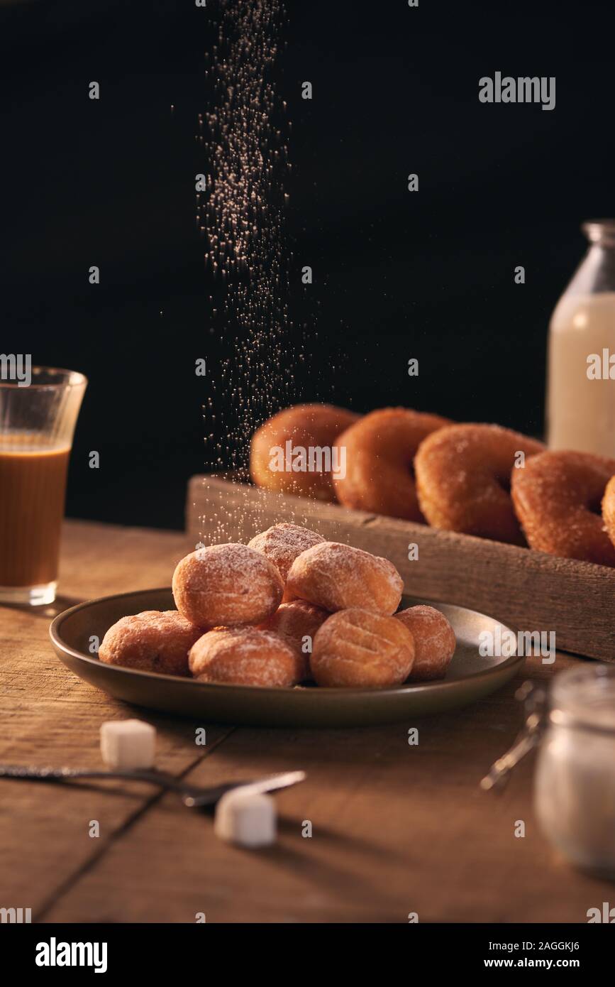 Small balls of freshly baked homemade cottage cheese doughnuts in a plate on a gray background. Stock Photo