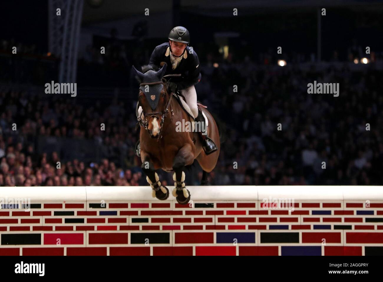LONDON, ENGLAND - DECEMBER 18TH William Whitaker riding RMF Charly during the Cayenne Puissance Event at the International Horse Show at Olympia, London on Wednesday 18th December 2019. (Credit: Jon Bromley | MI News) Stock Photo