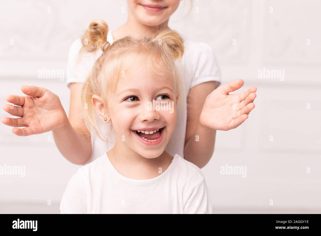 Two Little Blond Girls Fooling Around And Play With Each Other Stock