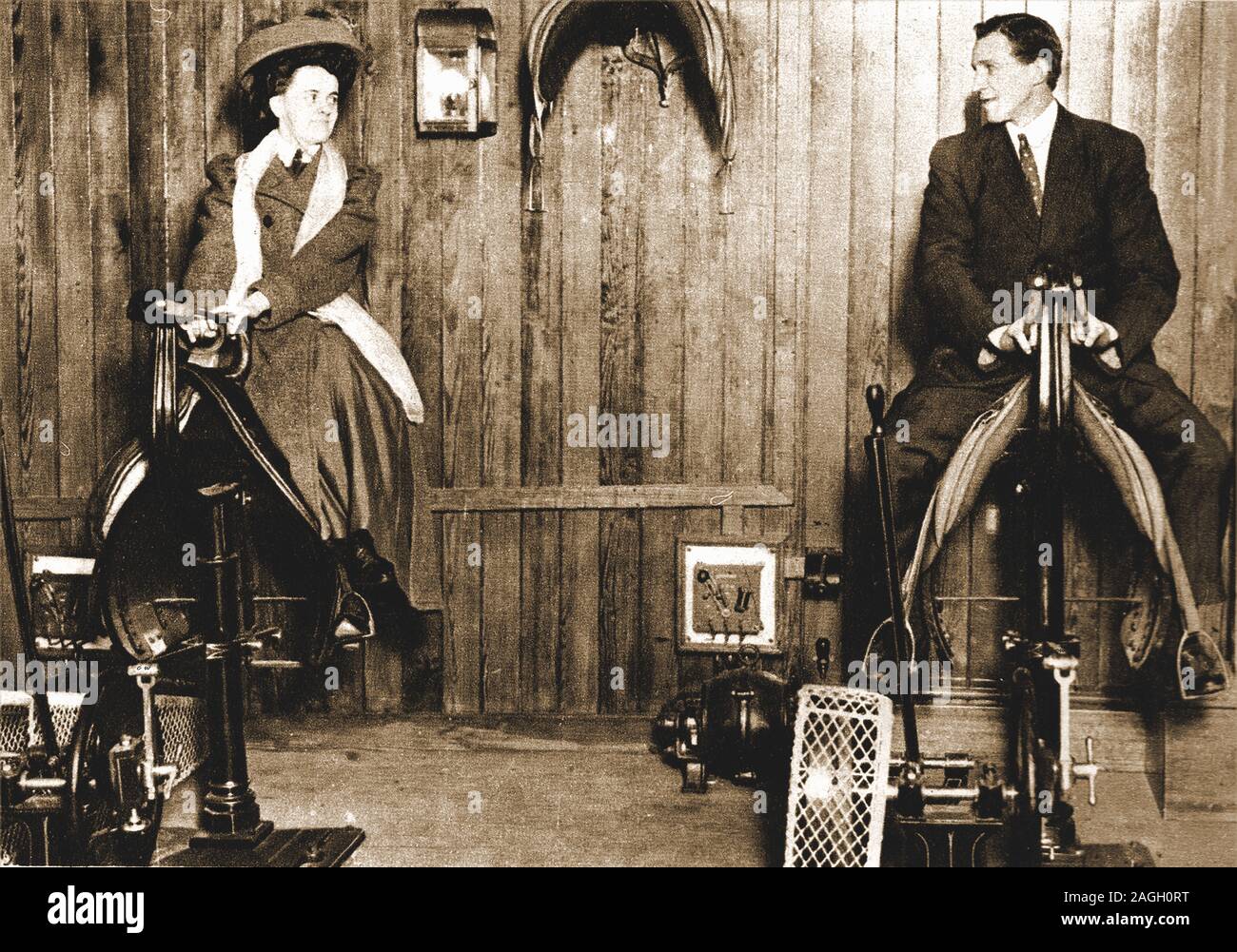 A 1912 photograph of a man and woman in formal dress riding 'mechanical horses', said to be in the gym on the  ill fated  luxury liner Titanic. Stock Photo