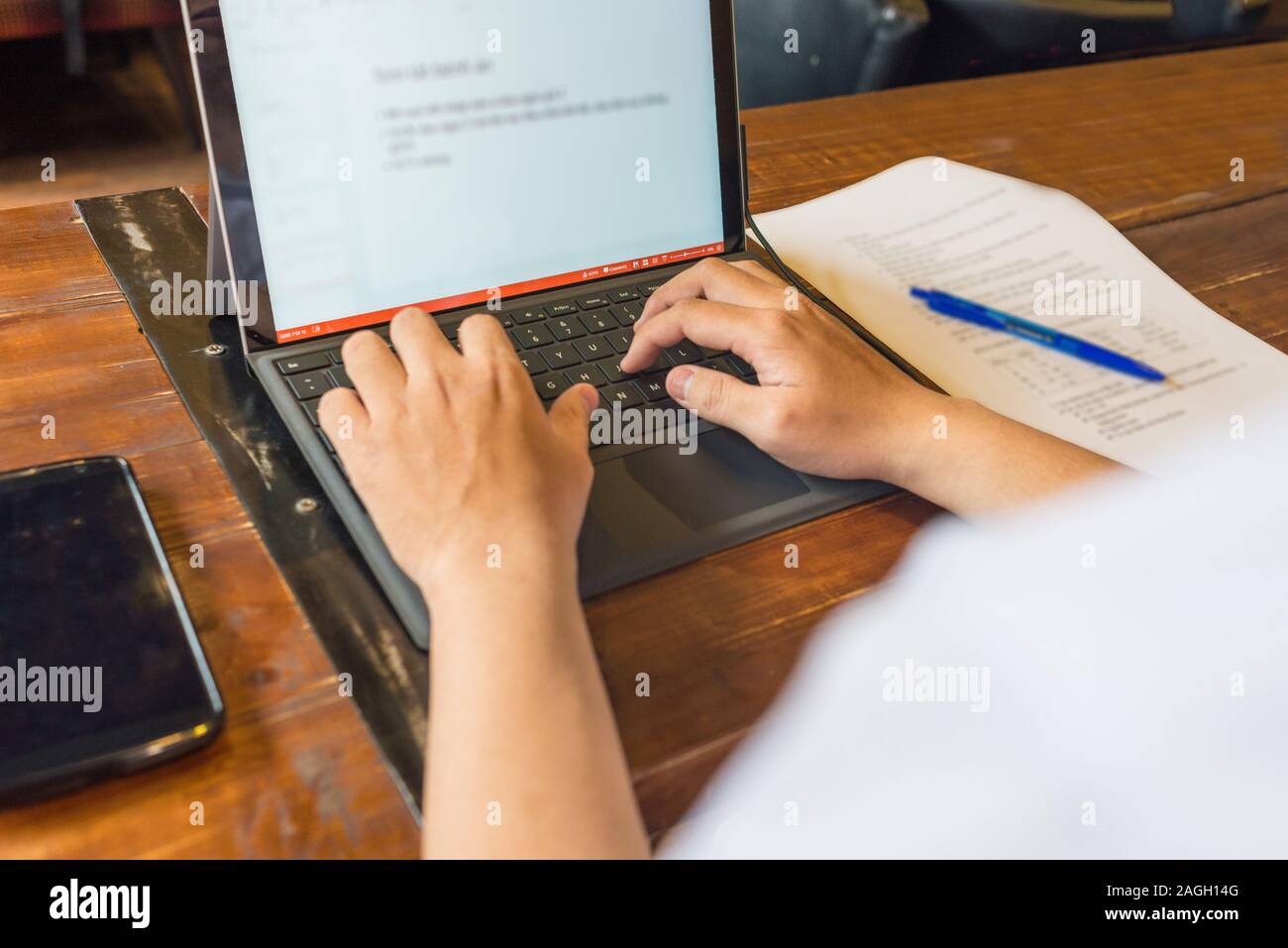 Close up photo of young man typing on laptop Stock Photo