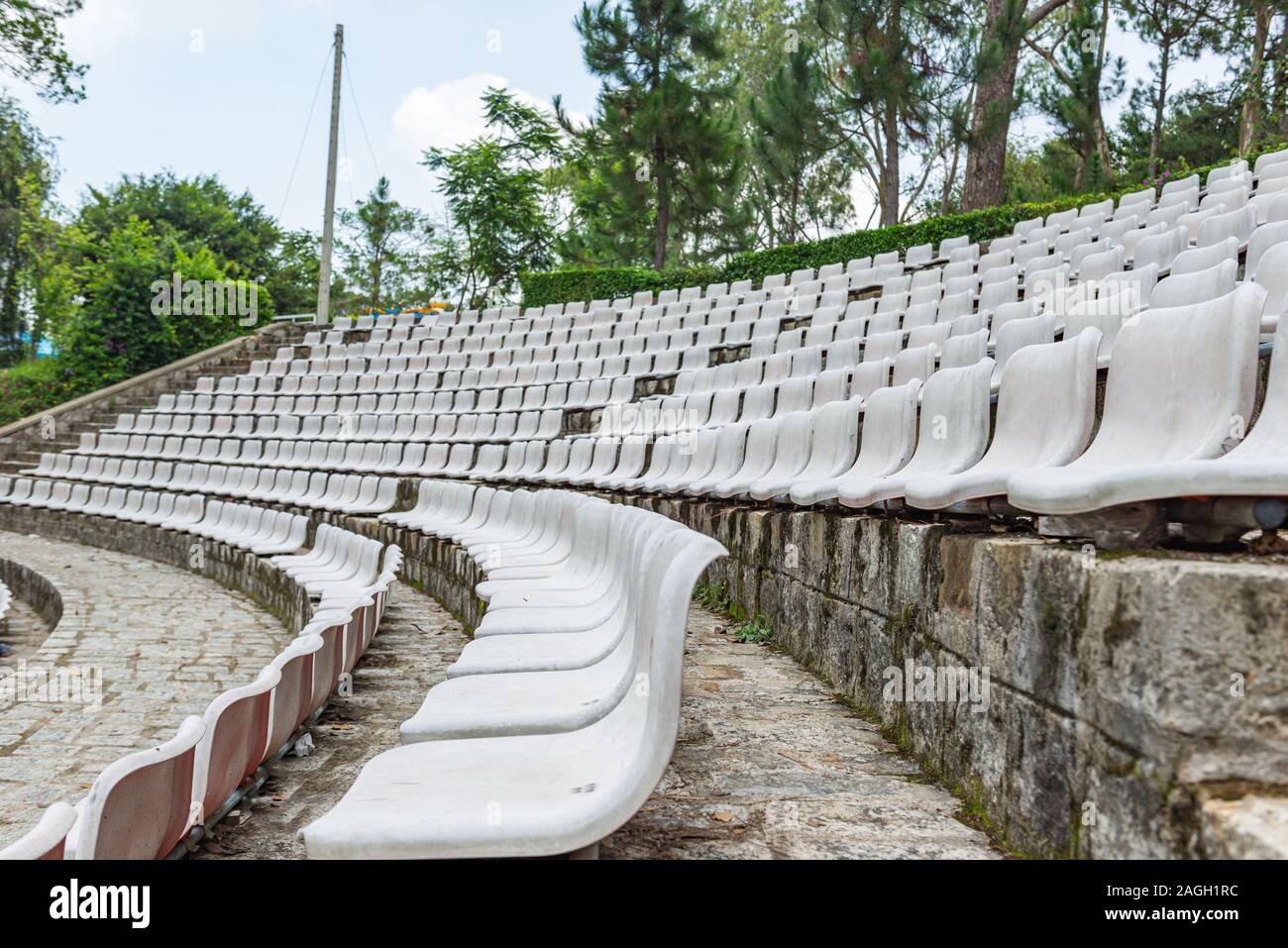 White plastic seat rows at outdoor stadium Stock Photo