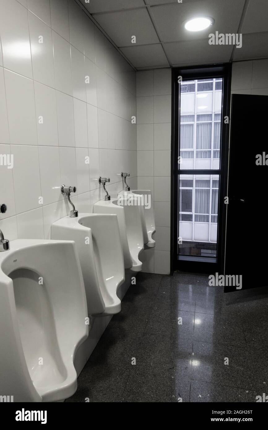 Unusual urinals with long window. Stock Photo