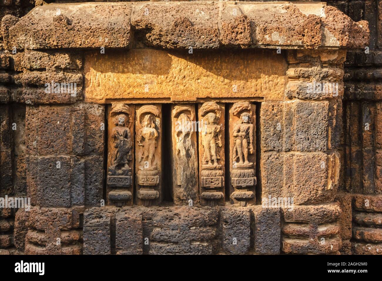 The artfully carved figurines on the laterite walls of an ancient Hindu temple in the city of Bhubaneshwar in Orissa, India. Stock Photo