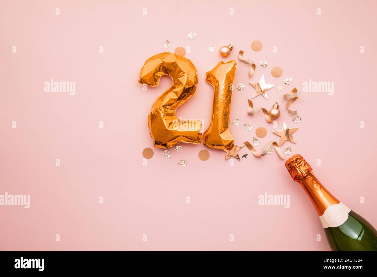 Happy 21st anniversary party. Champagne bottle with gold number balloon. Stock Photo