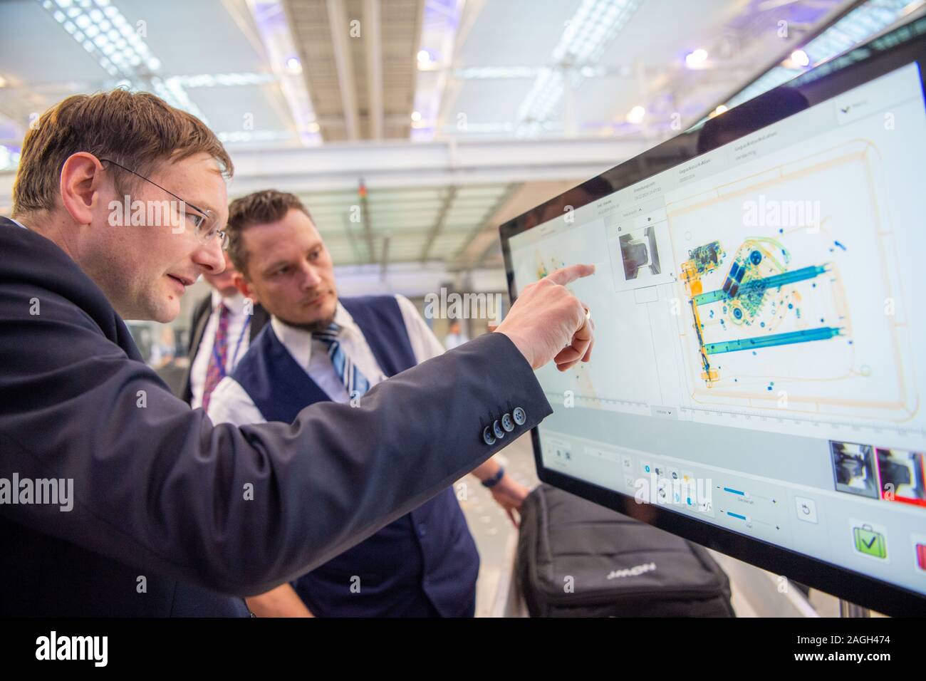 Munich, Germany. 19th Dec, 2019. Hans Reichhart (CSU), Minister of Transport of Bavaria, taps on the touch screen of a baggage control station at Munich Airport. Transportation Minister Reichhart, (CSU) announced the first test results of the newly installed safety system in a press conference. Credit: Lino Mirgeler/dpa/Alamy Live News Stock Photo