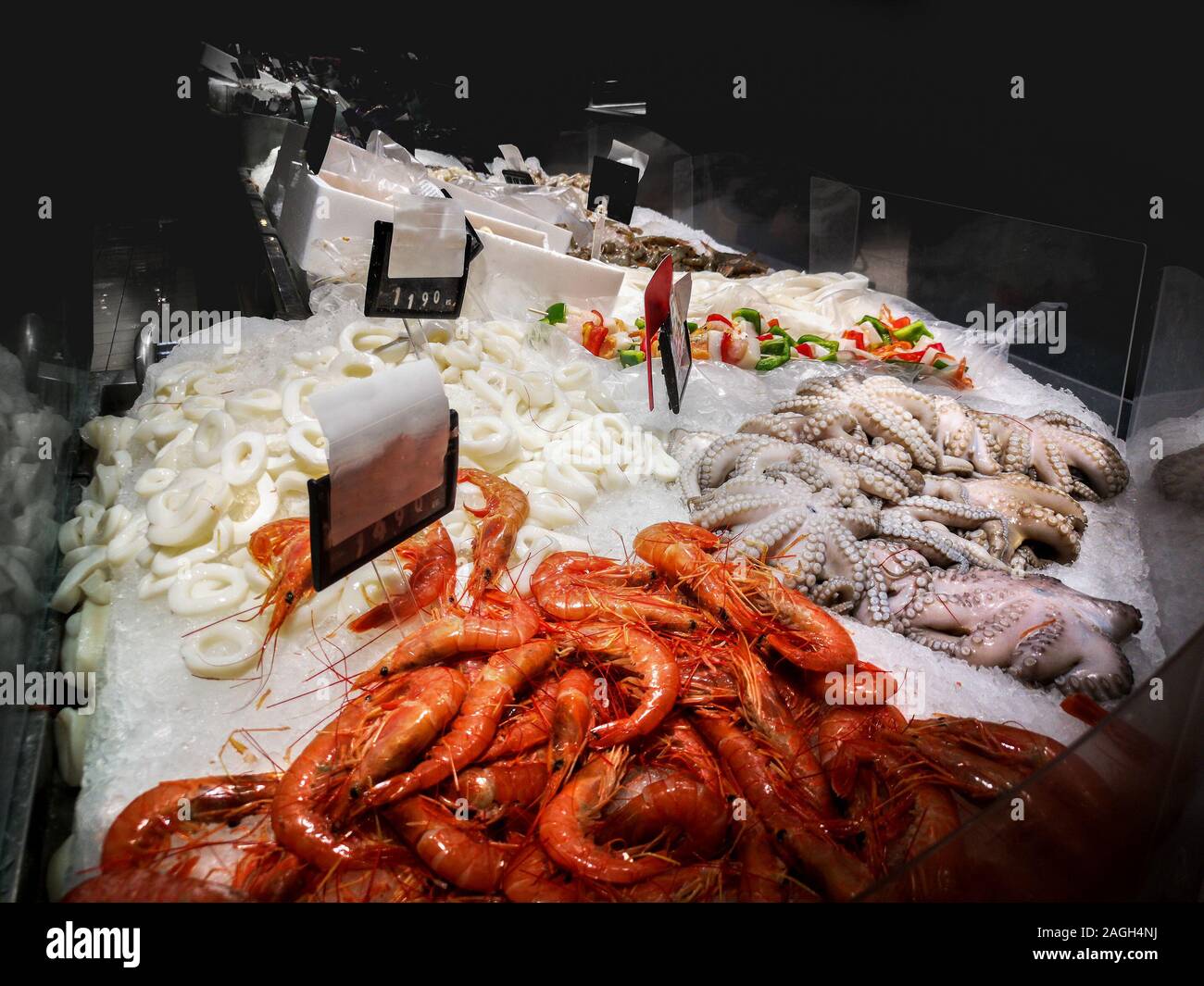 fishmonger bar counter with shrimps , octopus and other fresh seafood Stock Photo