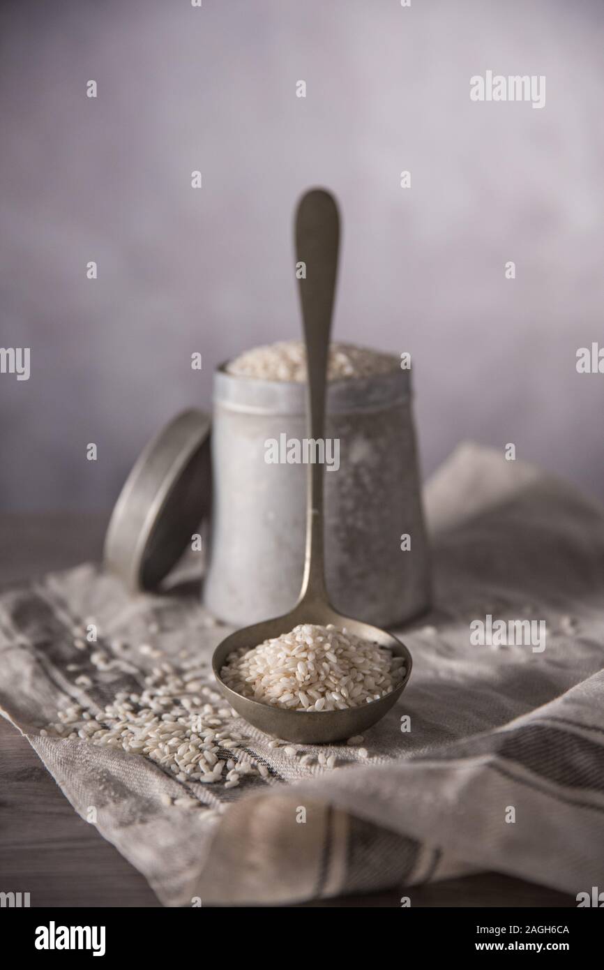 Ladled Rice Raw Rice on ladle with a container and a towel Stock Photo - Alamy
