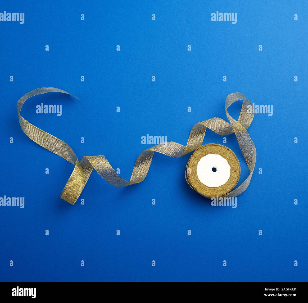 Shiny Golden Satin Ribbon On A Blue Background Beautiful Banner