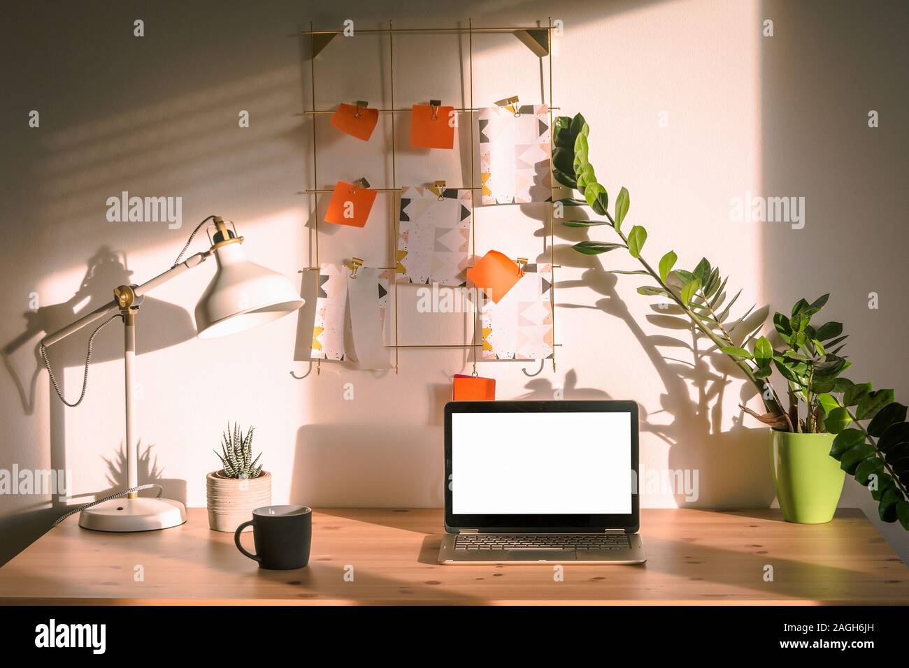 Working table near the wall with a laptop with mockup empty screen with copy space for content Stock Photo