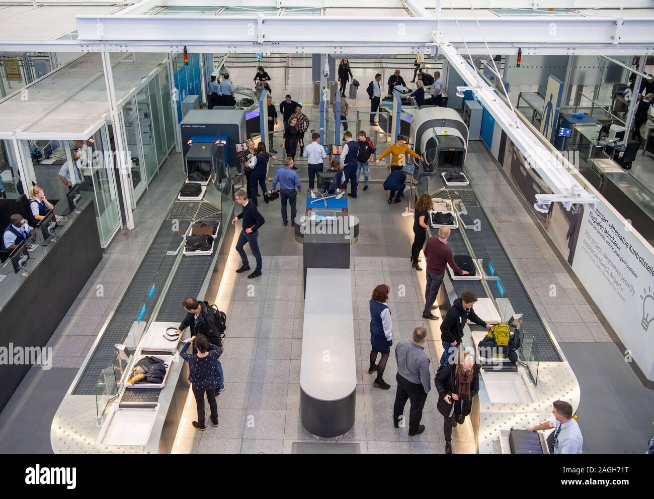 Munich, Germany. 19th Dec, 2019. Passengers walk through the new security checkpoint at Munich Airport. Transportation Minister Reichhart, (CSU) announced the first test results of the newly installed safety system in a press conference. Credit: Lino Mirgeler/dpa/Alamy Live News Stock Photo