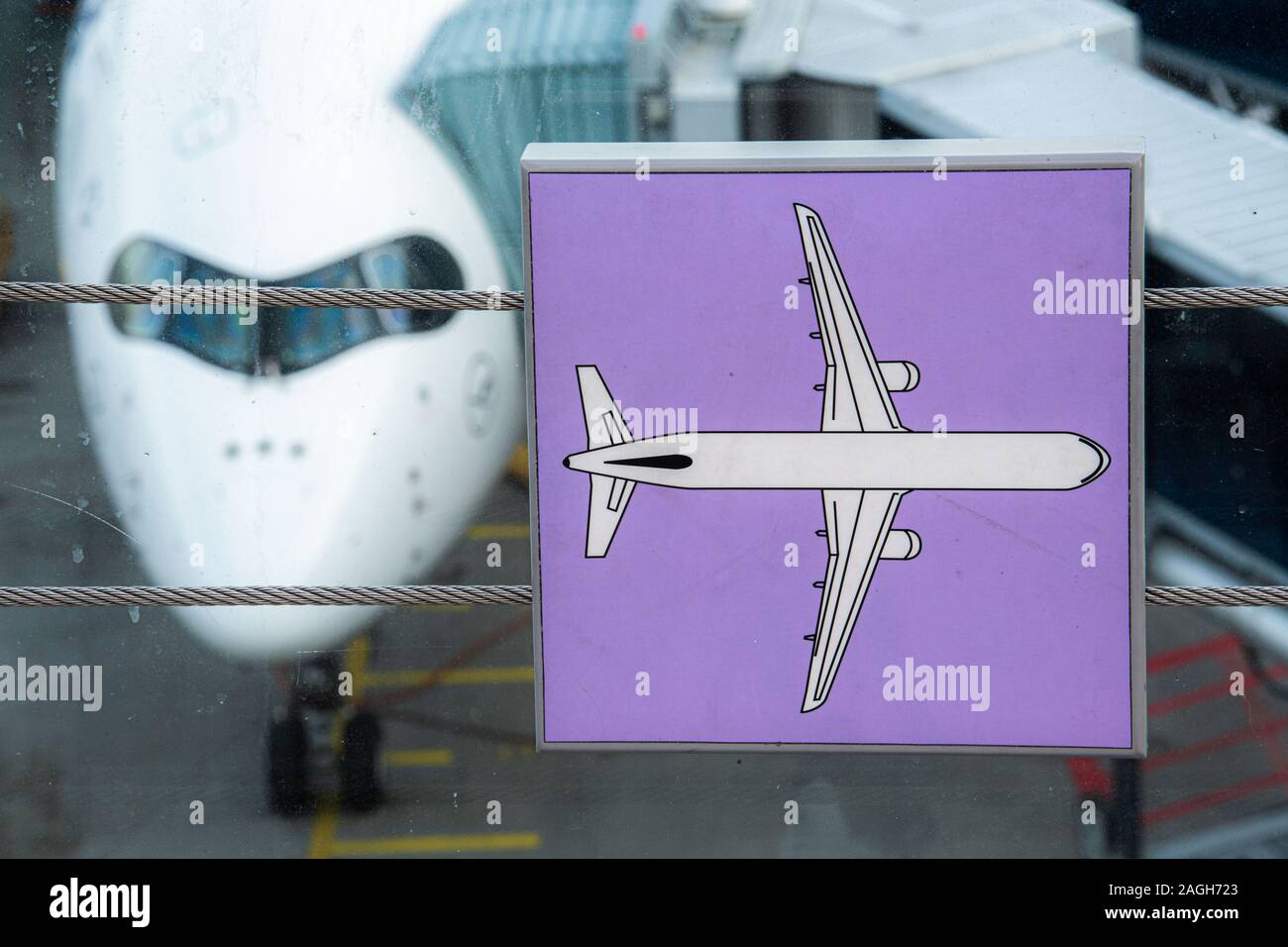 Munich, Germany. 19th Dec, 2019. A Lufthansa aircraft is docked at the gate at Munich Airport behind a symbol of an airplane at a children's play station. In a press conference, Transport Minister Reichhart (CSU) announced the first test results of the newly installed safety system. Credit: Lino Mirgeler/dpa/Alamy Live News Stock Photo