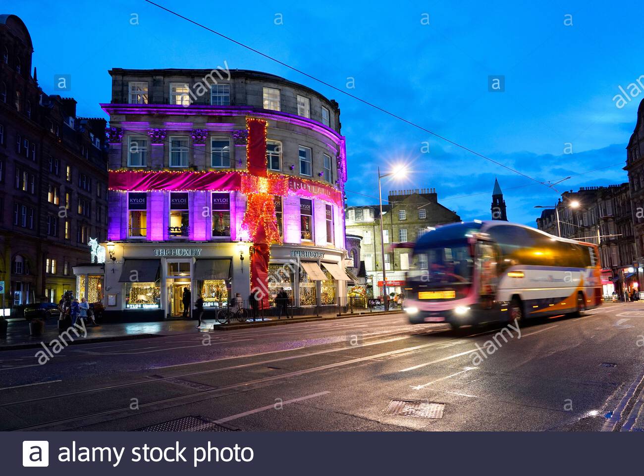 Edinburgh, Scotland, UK. 19th  Dec 2019. Dusk as a bus passes the Huxley bar and Restaurant decorated in Christmas lights in Shandwick Place in the West End. Credit: Craig Brown/Alamy Live News Stock Photo