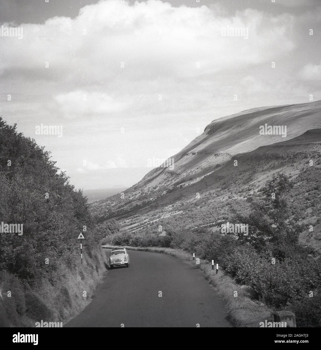1950s, historical, a motorcar of the era parked in a country road in the mountains of the Co. Antrim, Northern Ireland. Stock Photo